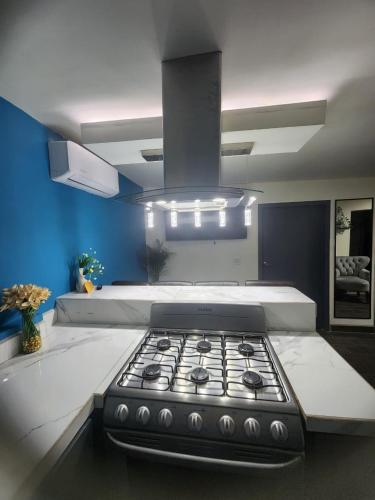a kitchen with a stove top in a room at Ocean blue in San Felipe