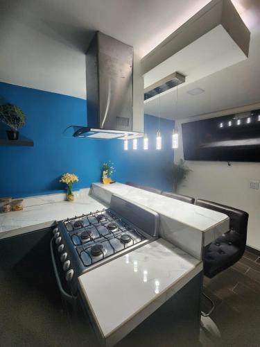 a kitchen with a stove and a blue wall at Ocean blue in San Felipe