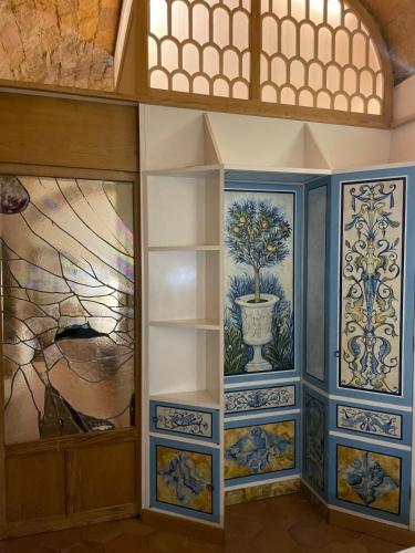 a room with blue and white walls with paintings on the walls at Roman times experience in Monti area in Rome