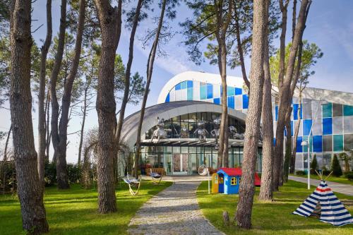 a building with a playground in front of it at Paragraph Resort & Spa Shekvetili, Autograph Collection in Shekvetili