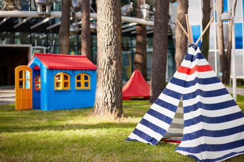 a toy playground with a toy house and a flag at Paragraph Resort & Spa Shekvetili, Autograph Collection in Shekvetili