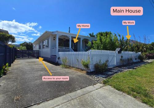 a small house with a main house and a man house at Tairua Garden Hideaway - Homestay with Private Room in Tairua