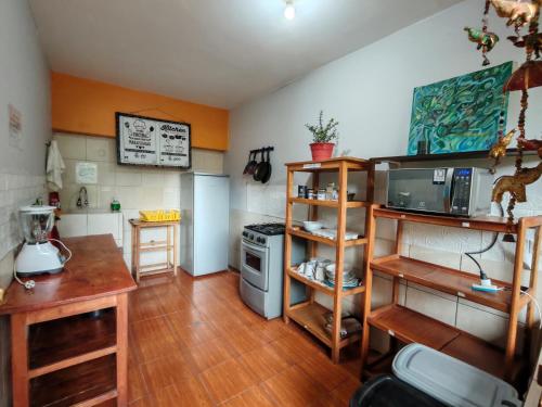 a kitchen with a counter and a stove in a room at Hospedaje Chaska Pisac in Pisac