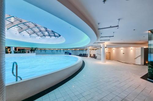 a pool on a cruise ship with blue lights at Hanza Tower Apartment no 2210 - 22nd floor, swimming pool, jacuzzi, panorama view in Szczecin