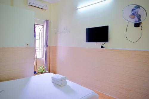 a room with a bed and a flat screen tv at Hue Ancient Town - Homestay in Hue in Hue