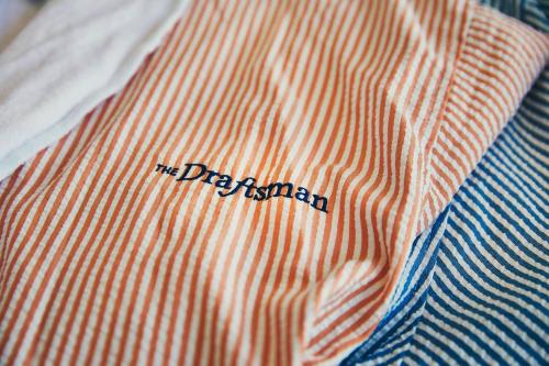 an orange and blue striped shirt with the drizann on it at The Draftsman, Autograph Collection in Charlottesville