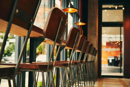 a row of chairs lined up in a restaurant at The Draftsman, Autograph Collection in Charlottesville