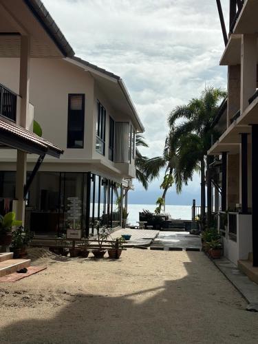 a house on the beach with the ocean in the background at Rin Bay View Resort in Haad Rin