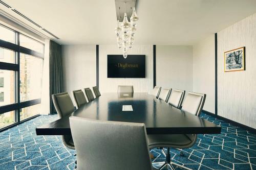 a conference room with a black table and chairs at The Draftsman, Autograph Collection in Charlottesville