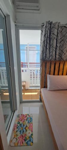 a room with a window and a bed with a view at Gomez Guest House in Tagbilaran City