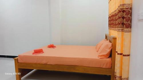 a small bed in a room with a bunk bed at Dolphin Village in Kalpitiya