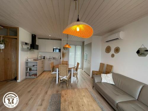 un salon avec un canapé et une table dans l'établissement Maison moderne avec clim, jardin et parking, proche plage Noirmoutier - FR-1-426-565, à Barbâtre