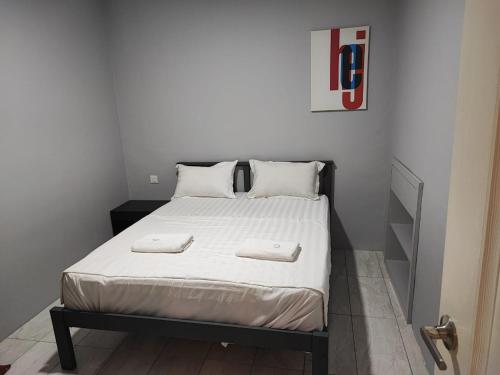 a bedroom with a bed with two towels on it at Air Putih Homestay 23 in Kuantan