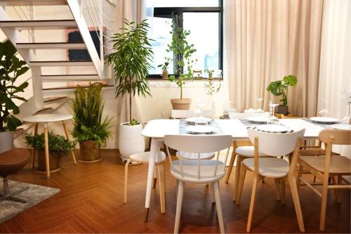 a dining room with a table and some plants at Hotel Voll in Seoul