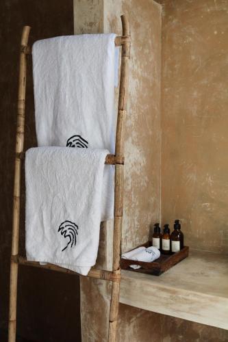 a towel sitting on a chair in a bathroom at Swell Shacks in Matara