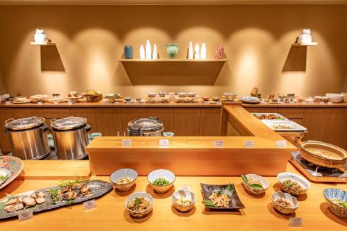 a restaurant with plates of food on a table at Kissuien Stay&Food in Kyotango