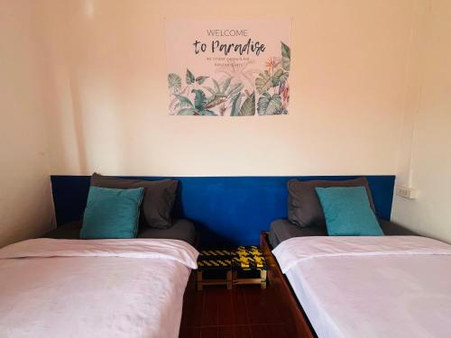 two beds sitting next to each other in a room at 1 Min to Slow Boat Guesthouse in Ban Khonkèo
