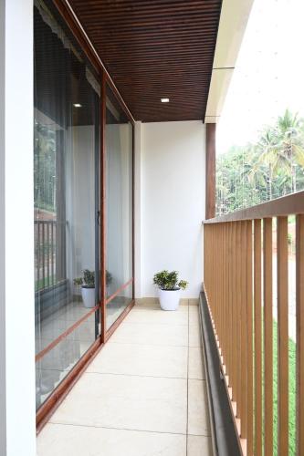 an empty balcony with potted plants on it at Hotel Aamis Villa in Pulpally