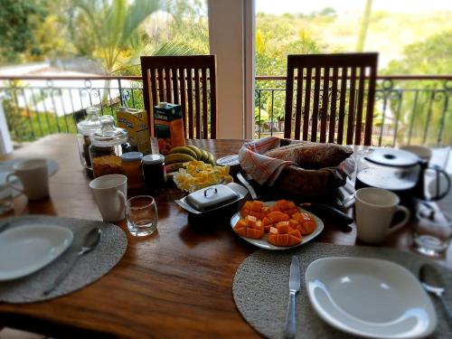 a wooden table with food on top of it at Chambre d'hôte La Mare Ronde in Grand Baie