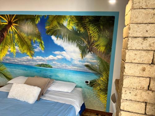 a bedroom with a view of the ocean and palm trees mural at Pompei Sunday Estate Exclusive Apartaments in Pompei