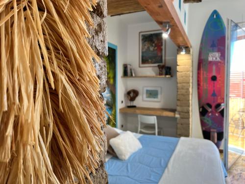 a living room with a blue couch and a surfboard at Pompei Sunday Estate Exclusive Apartaments in Pompei