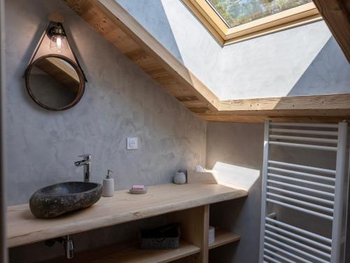 a bathroom with a sink and a skylight at Chambre apaisante avec sauna et petit-déjeuner inclus - FR-1-589-714 in Sapois