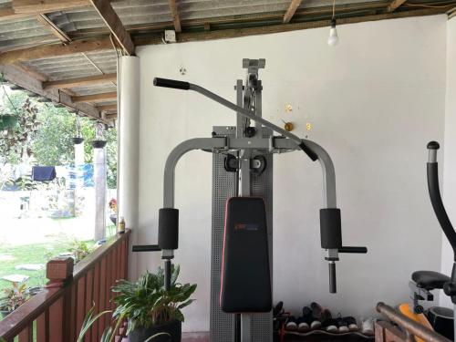 a gym machine in a room with a wall at Kandy Food Lovers Home Stay by AGS in Kandy