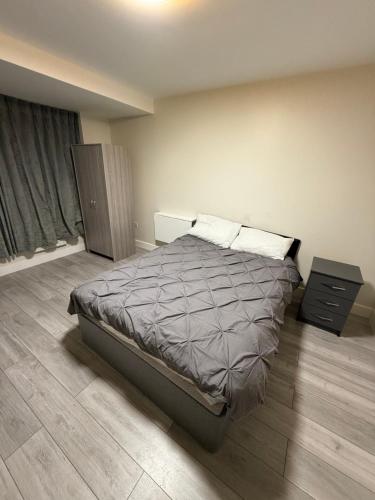a bedroom with a bed and a dresser in it at Riverside in London