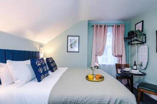 a bedroom with a bed with a bowl of fruit on it at Victoria Park Studio 8 with Private Off-suite Shower Room down a flight of stairs from the main room, Free Parking, Free Netflix, Prime & DisneyPlus in Leamington Spa