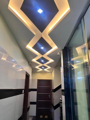 a ceiling with lights in a hallway with a door at Galaxy beach residency in Velankanni