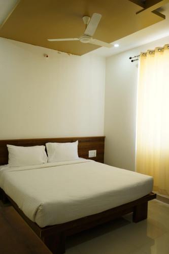 ein Schlafzimmer mit einem Bett und einem Deckenventilator in der Unterkunft HOTEl MARKS INN in Munirābād