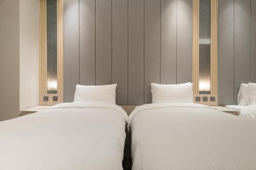 Postel nebo postele na pokoji v ubytování Gamalan Breeze Hotel
