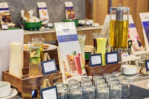 a table topped with jars of food and drinks at Cygnett Inn Airport in Mohāna