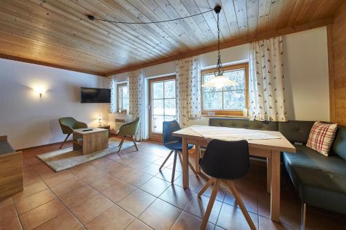 a kitchen and living room with a table and chairs at Appartement Kolling in Saalbach Hinterglemm