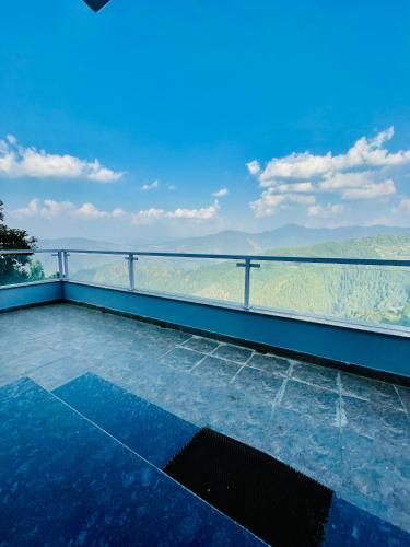 a balcony with a view of the mountains at Yarrows, Narkanda, A boutique stay in Nārkanda