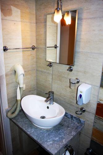 a bathroom with a sink and a mirror at Camlikosk Apart Hotel in Bodrum City