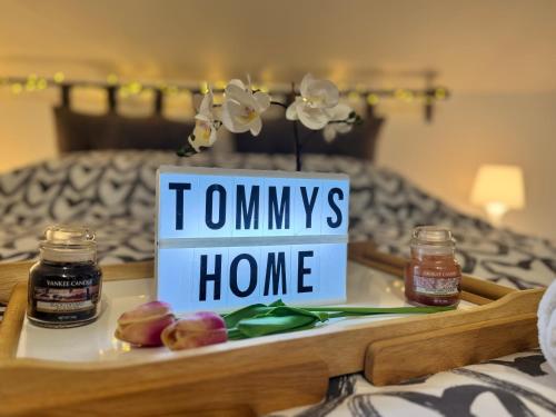 a tray with a tray of honey and a sign that reads township home at Tommy's Home in Turin