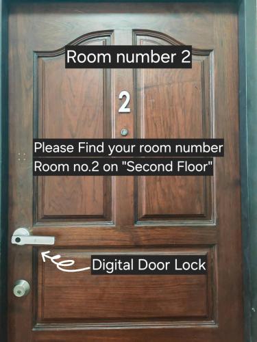a wooden door with a room number and a room no on second floor at 57 Hidden House BKK Chinatown in Bangkok