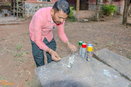 a man is cooking food on a table at Avanti Kalagram Hill Top Resort, Mulshi in Kolvan
