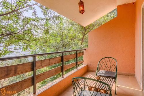 a balcony with a chair and a view of trees at Avanti Kalagram Hill Top Resort, Mulshi in Kolvan
