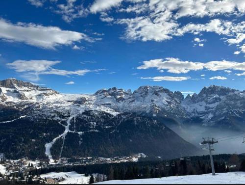 a snow covered mountain range with a ski lift at Residence Sole Alto Marillleva 1400 - vista bosco in Marilleva