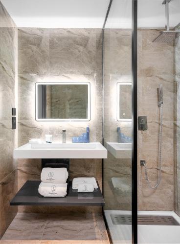 a bathroom with a sink and a shower at The Bickley Park Hotel in Lekki