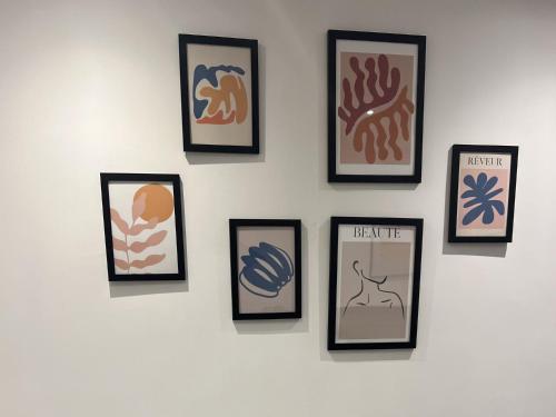 a wall with four framed pictures on a wall at Secret Square View Apartment Pass The Keys in Brighton & Hove