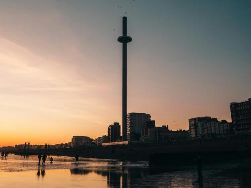 a city skyline with a tall tower in the sunset at Secret Square View Apartment Pass The Keys in Brighton & Hove