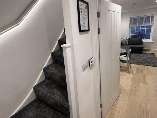 a hallway with a stairway leading to a living room at Secret Square View Apartment Pass The Keys in Brighton & Hove