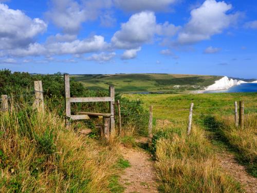 a fence on the side of a hill with a beach at Secret Square View Apartment Pass The Keys in Brighton & Hove