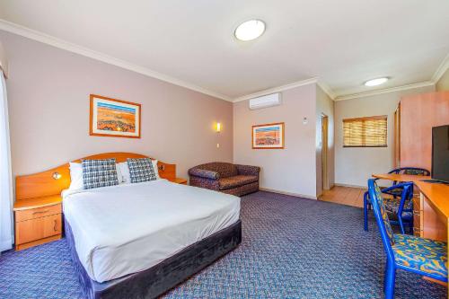 a hotel room with a bed and a television at Quality Inn Penrith Sydney in Penrith