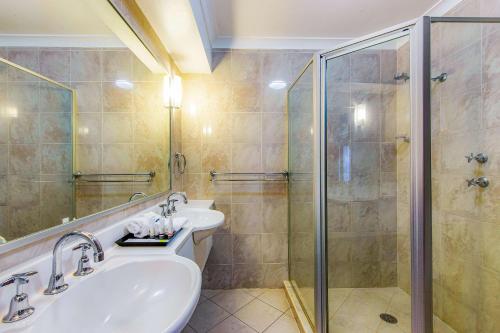a bathroom with a sink and a shower at Quality Inn Penrith Sydney in Penrith