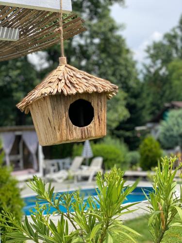 a wooden birdhouse hanging from a roof at CHALET Orsova in Orşova