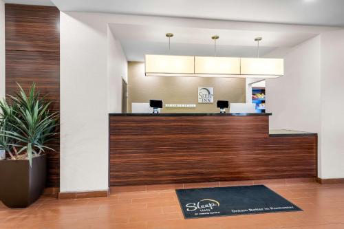 an office with a reception desk in a lobby at Sleep Inn & Suites West-Near Medical Center in Rochester